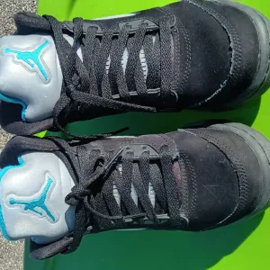 Black and Gray Sneakers with Teal Logo