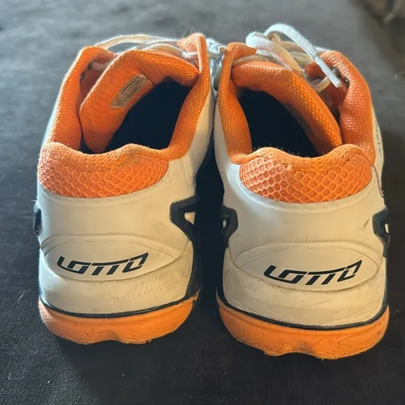 Lotto men’s sneaker tennis shoes in white with bright orange accents