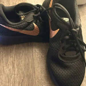 Nike Black and gold tandem running shoes
