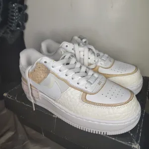 Nike White and Tan Athletic Shoes with Iconic Air Force 1 Design